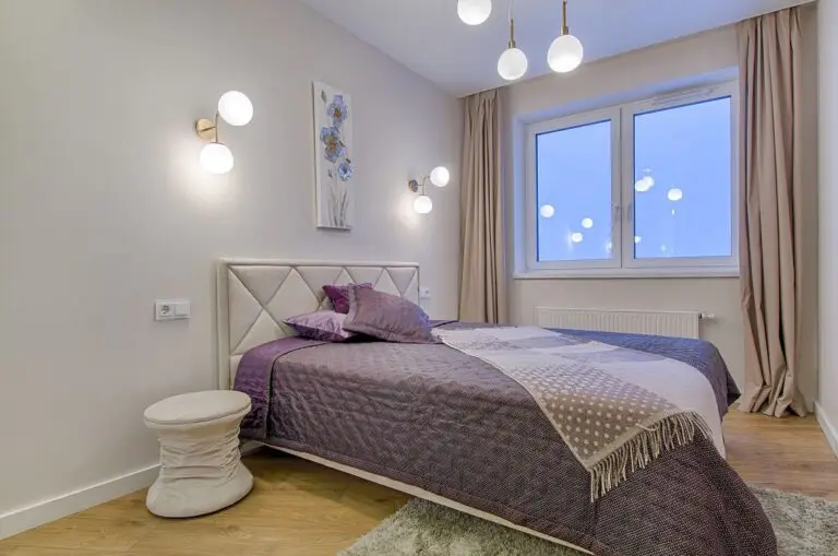 Bright room with a large bed and a seating area by the window
